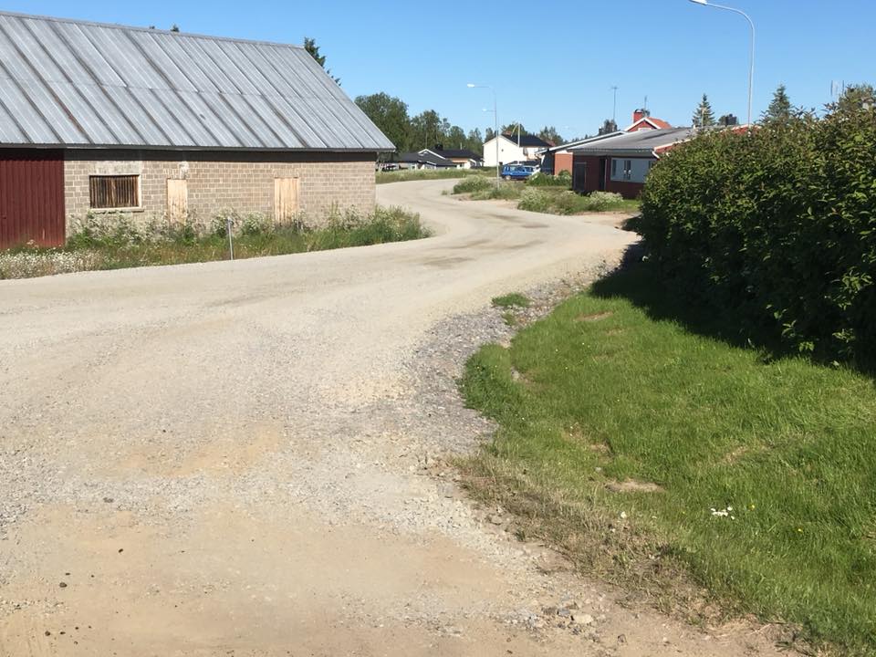 Bild på en grusväg inne i ett samhälle
